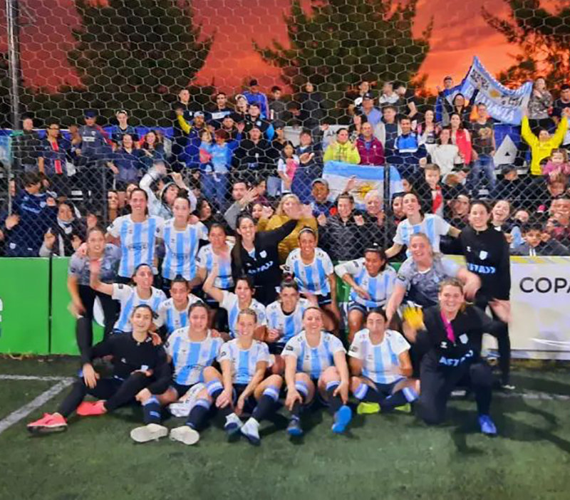 Johana Crocco con el plantel argentino con la hinchada de fondo, en Comodoro Rivadavia