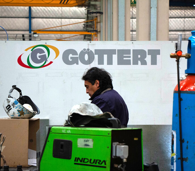 Operario frente al cartel de Göttert dentro de la planta
